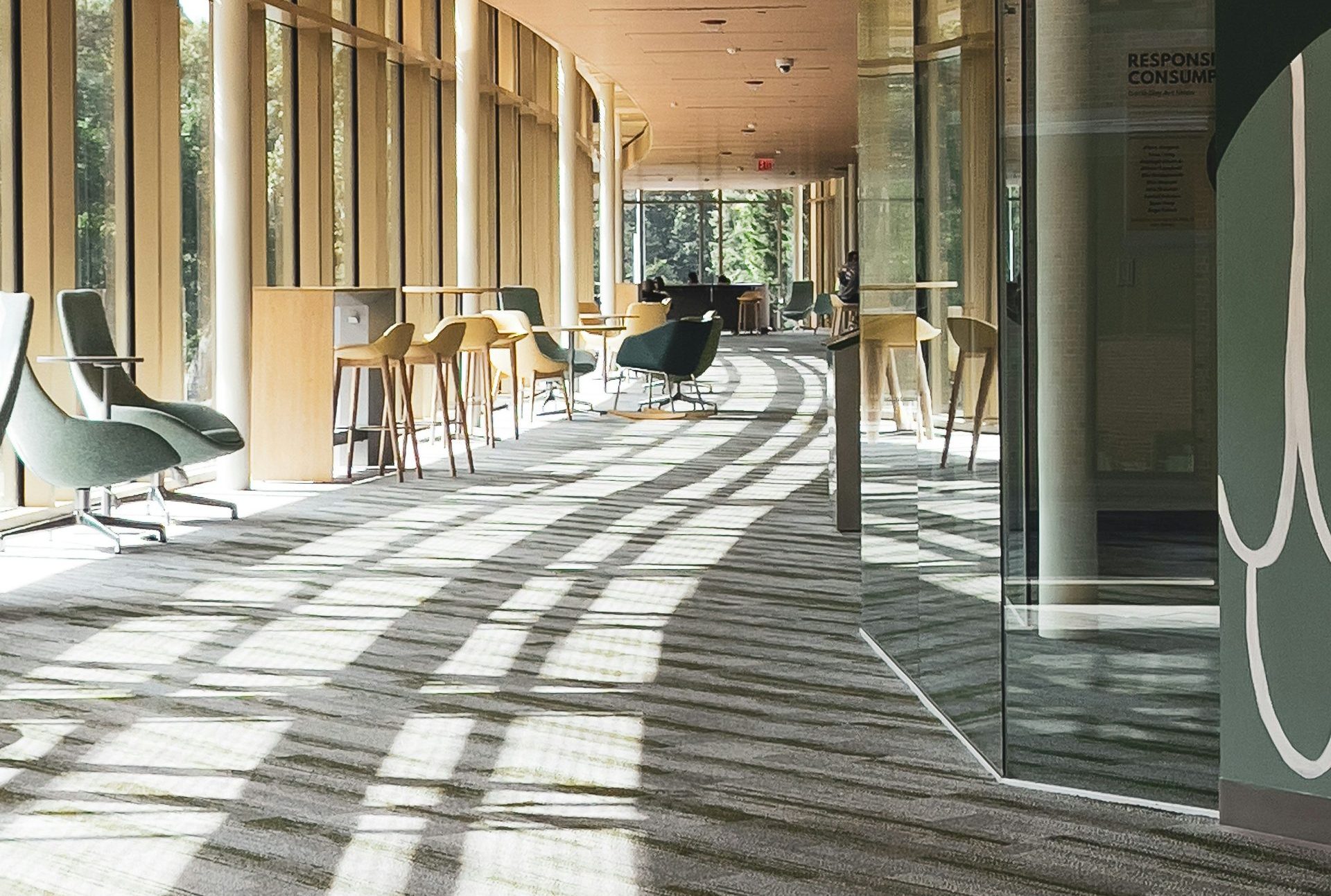 a long hallway with chairs and tables in it
