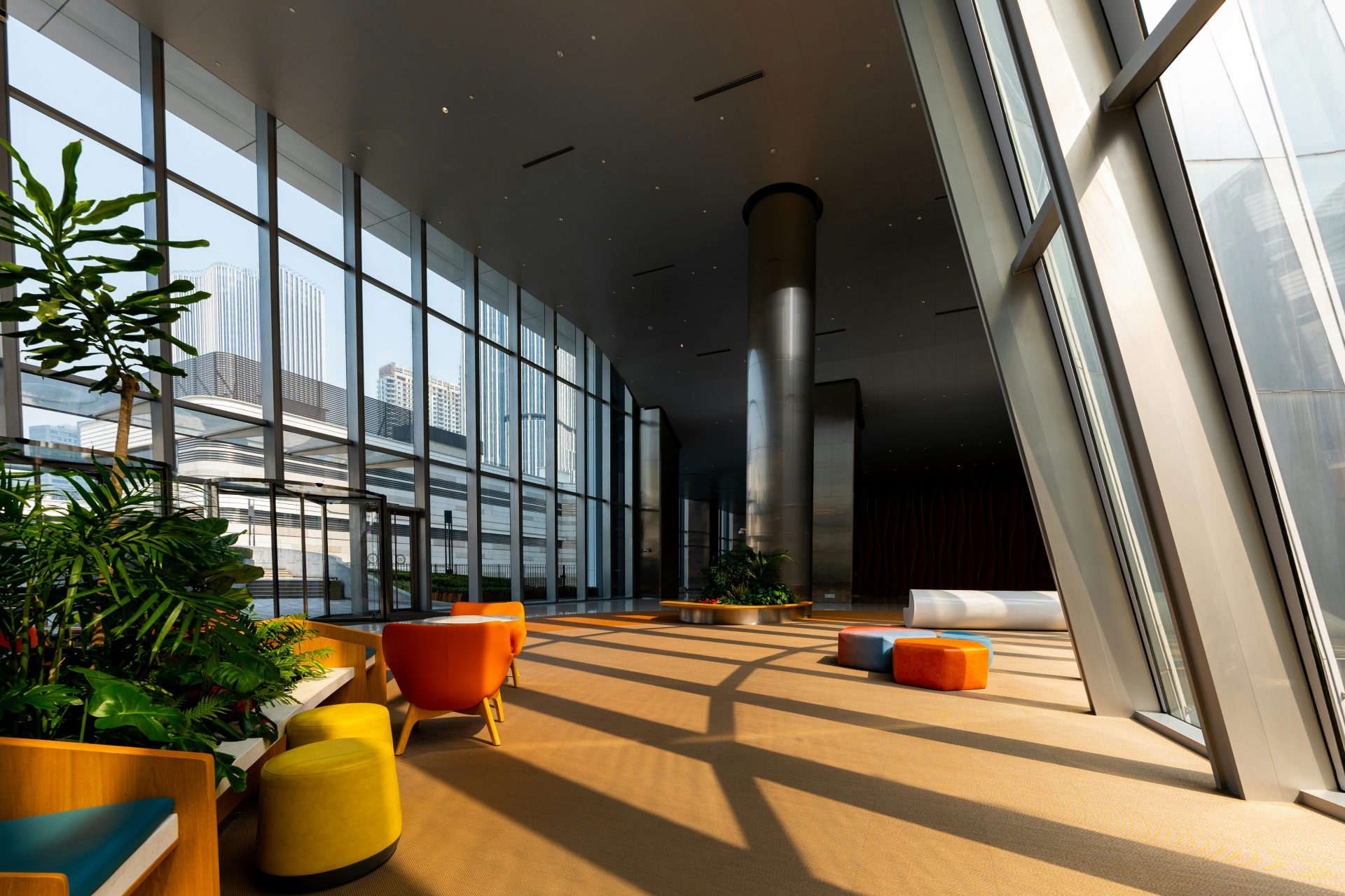 A modern lobby with colorful furniture and windows.